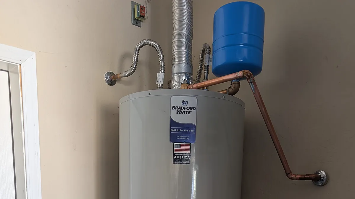 Bradford White gas water heater installed with a new thermal expansion tank, copper water lines and flexible gas connector