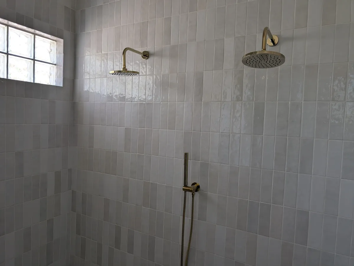 Walk-in shower with dual brass rainheads and handheld sprayer, Prescott bathroom remodel