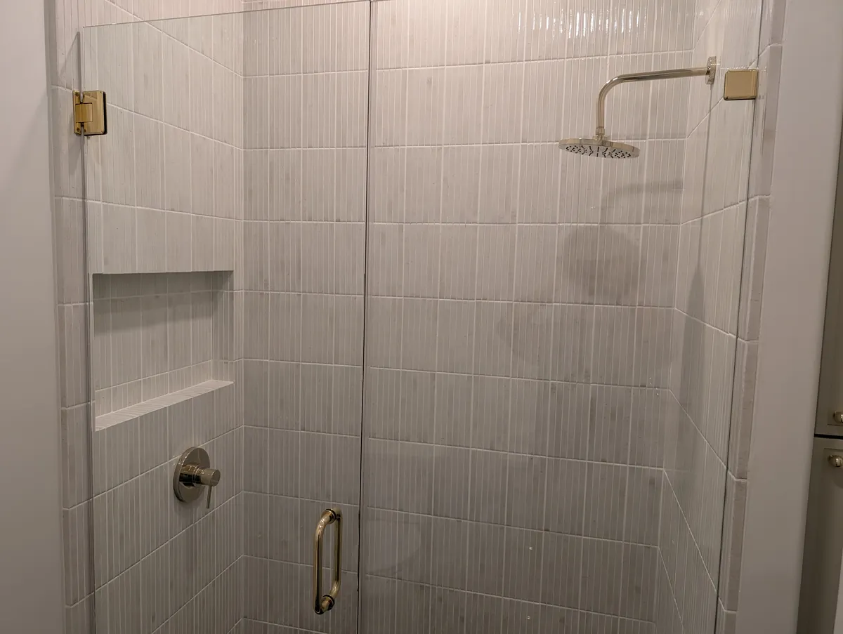 Frameless glass walk-in shower with chrome valve and rainhead, Prescott bathroom